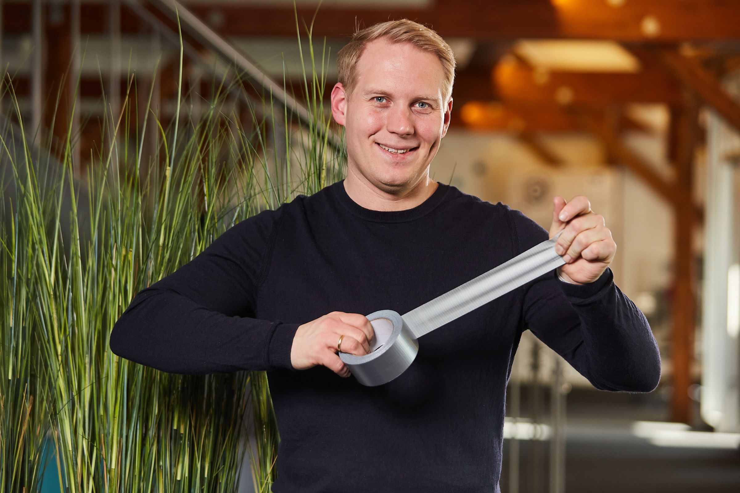 Peter Bonner holding a roll of tape as a light hearted symbol of pragmatism.
